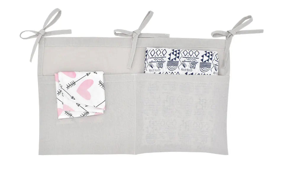 Discover BubeBaby's Nursery Crib Organizer, perfect for babies aged 0-1Y. Available in unisex colors (gray, pink, beige, navy blue), this versatile organizer comes in two styles: Canvas (29x49cm) and Muslin (20x39cm). Made from durable linen and ideal for year-round use, it keeps your nursery tidy and stylish