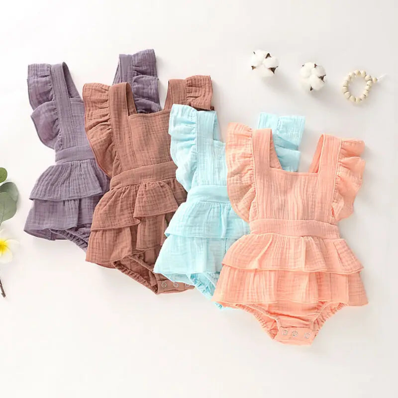 BabyLove Ruffled Jumpsuit at BubeBaby, perfect for baby girls aged 0-18 months. Made from soft cotton and polyester, this fashionable romper features a stylish O-neck and ruffled design.  it's ideal for spring and autumn