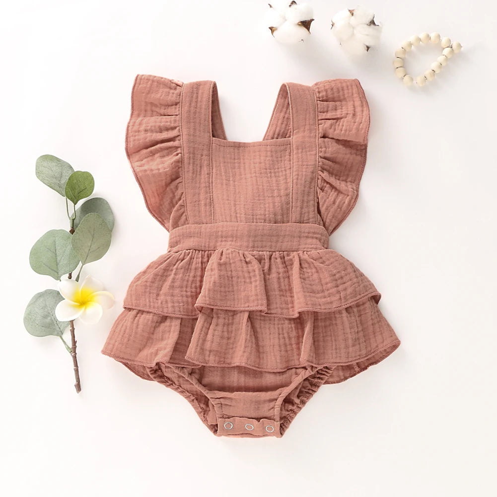 BabyLove Ruffled Jumpsuit at BubeBaby, perfect for baby girls aged 0-18 months. Made from soft cotton and polyester, this fashionable romper features a stylish O-neck and ruffled design.  it's ideal for spring and autumn