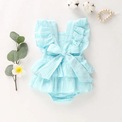 BabyLove Ruffled Jumpsuit at BubeBaby, perfect for baby girls aged 0-18 months. Made from soft cotton and polyester, this fashionable romper features a stylish O-neck and ruffled design.  it's ideal for spring and autumn