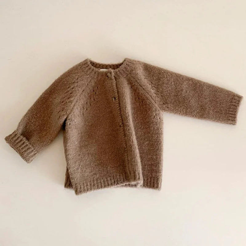 BabyLove Knitted cardigan for baby girls in a blend of cotton and wool. Features O-neck, button closure, and full-length sleeves. Available in sizes 0-4 years. Solid pattern, suitable for spring, autumn, and winter. Soft, warm woolen fabric