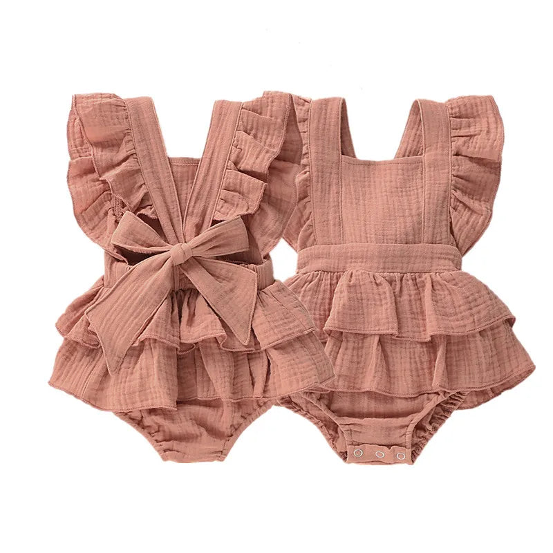 BabyLove Ruffled Jumpsuit at BubeBaby, perfect for baby girls aged 0-18 months. Made from soft cotton and polyester, this fashionable romper features a stylish O-neck and ruffled design.  it's ideal for spring and autumn