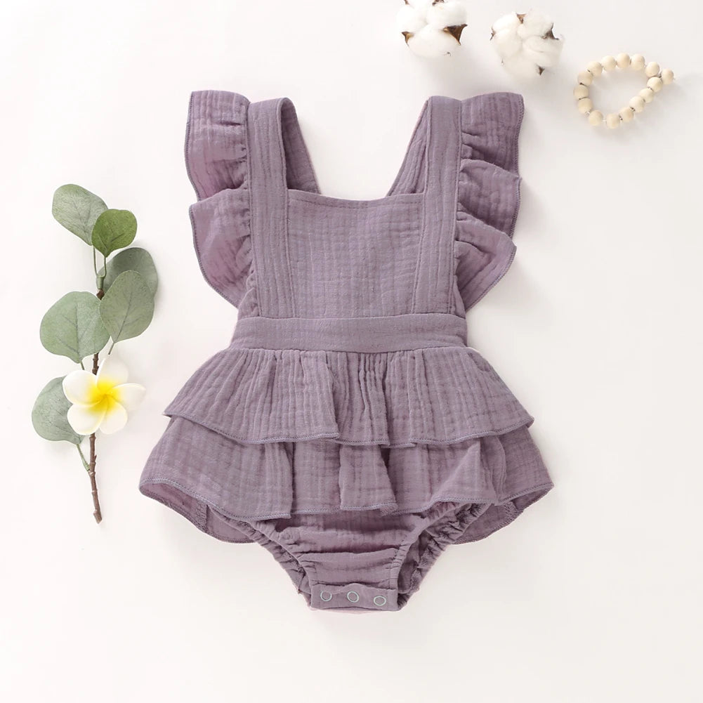 BabyLove Ruffled Jumpsuit at BubeBaby, perfect for baby girls aged 0-18 months. Made from soft cotton and polyester, this fashionable romper features a stylish O-neck and ruffled design.  it's ideal for spring and autumn