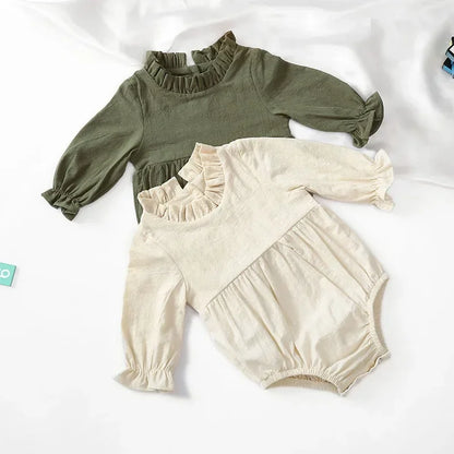 Bubebaby BabyLove Cotton Ruffled Long Sleeve buttoned Romper.  A cute and cozy baby romper made from soft cotton fabric, featuring long sleeves, a ruffled collar and wrists, with a snap closure for easy dressing. 