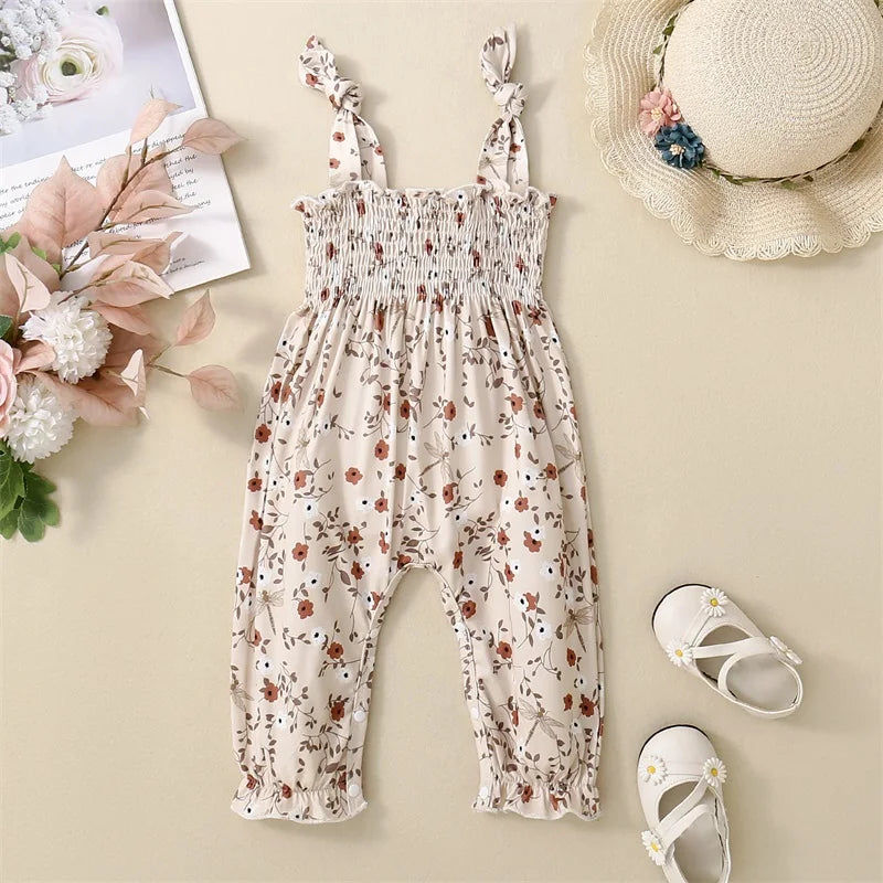 Bubebaby BabyLove Floral Jumpsuit Romper. The romper features a floral pattern with a mix of tranquil colors. Featuring an elasticized chest with shoulder straps, and snap closures at the bottom for easy diaper changes.