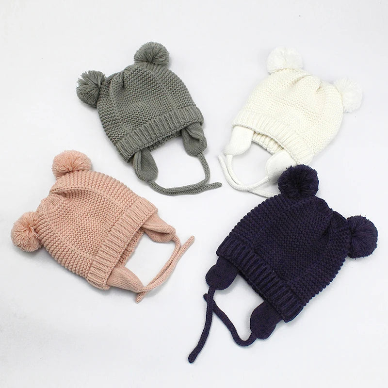 Shop the BabyLove Winter Knitted Bonnet at BubeBaby, perfect for keeping little ones warm in winter. Made from soft acrylic, this unisex bonnet features a solid pattern and ear protection design