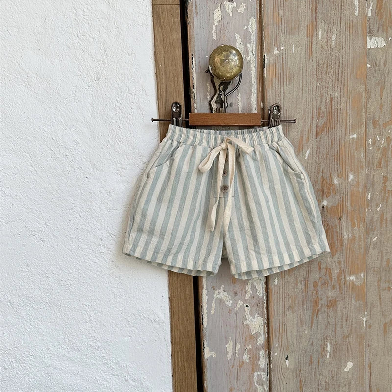 Shop our BabyLove Vintage Striped Shorts at BubeBaby. Perfect for summer, these unisex shorts feature a European and American style with a solid pattern. Made from soft cotton, they fit true to size and come in sizes ranging from 6-12m to 4-5T. Available in coffee, green, and beige. Ideal for ages 0-6 years