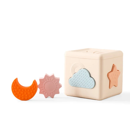 Babylove Silicone Tissue Box for kids aged 0-14+ years, free from high-concern chemicals. This Montessori toy enhances color recognition and shape pairing, made from high-quality silicone with a shape and nature theme. Ideal for developing early learning skills