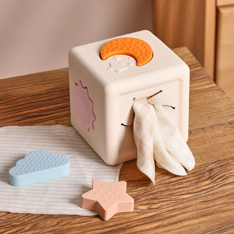 Babylove Silicone Tissue Box for kids aged 0-14+ years, free from high-concern chemicals. This Montessori toy enhances color recognition and shape pairing, made from high-quality silicone with a shape and nature theme. Ideal for developing early learning skills