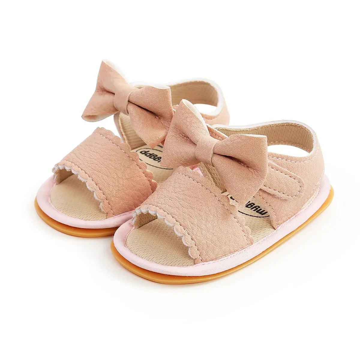 A cute pair of Bubebaby BabyLove  faux leather sandals for infants featuring an adorable bow detail. The sandals are designed for comfort and style, perfect for little ones to wear during warm weather. The adjustable strap ensures a secure fit while the soft sole provides cushioning for tiny feet