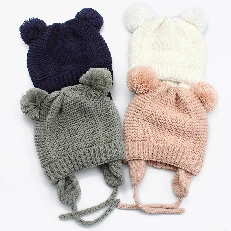 Shop the BabyLove Winter Knitted Bonnet at BubeBaby, perfect for keeping little ones warm in winter. Made from soft acrylic, this unisex bonnet features a solid pattern and ear protection design