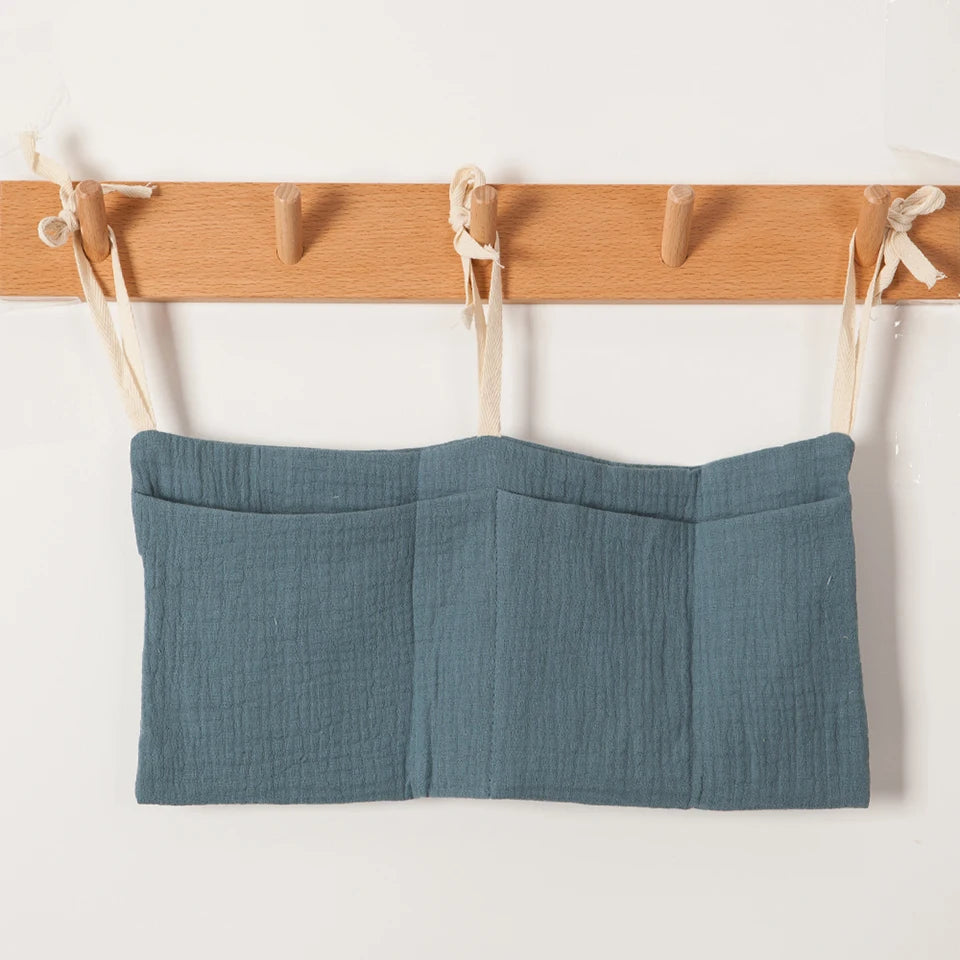 Discover BubeBaby's Nursery Crib Organizer, perfect for babies aged 0-1Y. Available in unisex colors (gray, pink, beige, navy blue), this versatile organizer comes in two styles: Canvas (29x49cm) and Muslin (20x39cm). Made from durable linen and ideal for year-round use, it keeps your nursery tidy and stylish