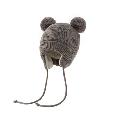 Shop the BabyLove Winter Knitted Bonnet at BubeBaby, perfect for keeping little ones warm in winter. Made from soft acrylic, this unisex bonnet features a solid pattern and ear protection design