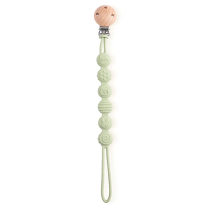 BabyLove Montessori Beech Wood and Silicone Beaded Pacifier Clip, a 20cm durable, BPA-free, phthalate-free, and latex-free accessory for babies aged 0-36 months. Features a solid color, wooden clip, and silicone strap. Versatile as a pacifier holder, soother chain, or teether toy. Safe and stylish design