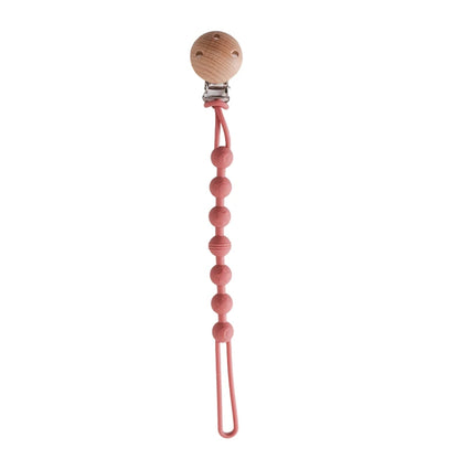 BabyLove Montessori Beech Wood and Silicone Beaded Pacifier Clip, a 20cm durable, BPA-free, phthalate-free, and latex-free accessory for babies aged 0-36 months. Features a solid color, wooden clip, and silicone strap. Versatile as a pacifier holder, soother chain, or teether toy. Safe and stylish design