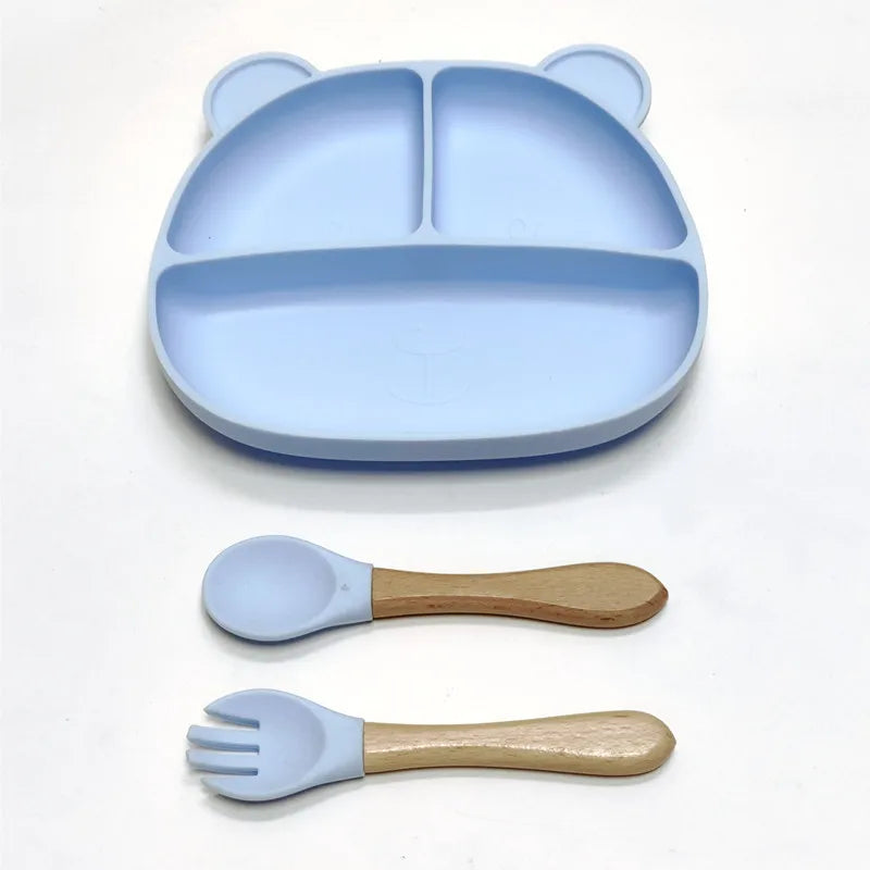 the BabyLove Silicone Dinner Plate with Cutlery at BubeBaby. Made from BPA-free silicone and CE certified, this dinnerware set is perfect for children aged 0-6 years. Featuring a solid pattern and multi-color options, it's designed for easy cleaning and safe feeding. Ideal for infants and toddlers