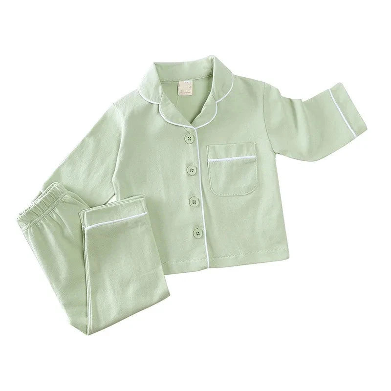 Discover our luxurious unisex cotton pajamas for kids aged 12 Mo- 5 Years at Bubebaby. Perfect for autumn, these solid-colored pajamas feature a classic turn-down collar and regular sleeves, offering comfort and style for your little ones