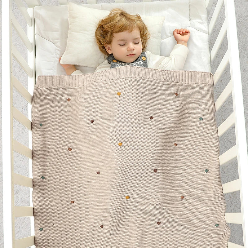 Nursery Knitted Newborn Baby Blanket at BubeBaby. Made from 100% cotton, this unisex blanket is perfect for babies aged 0-24 months. Featuring a versatile dot pattern, it’s ideal for all seasons. Soft and comfortable, it makes a great choice for keeping your baby cozy year-round