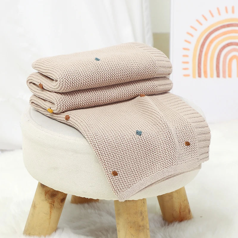 Nursery Knitted Newborn Baby Blanket at BubeBaby. Made from 100% cotton, this unisex blanket is perfect for babies aged 0-24 months. Featuring a versatile dot pattern, it’s ideal for all seasons. Soft and comfortable, it makes a great choice for keeping your baby cozy year-round