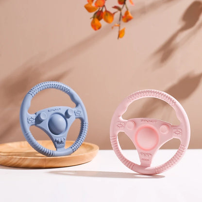 Silicone Bubebaby BabyLove Teething Toy Car Wheel – A fun and safe teether for babies, designed as an analog steering wheel. Made from 100% silicone, it's latex, nitrosamine, phthalate, BPA, and PVC free. Suitable for infants from 0 to 36 months. Available in various colors and comes in single packaging