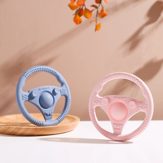 Silicone Bubebaby BabyLove Teething Toy Car Wheel – A fun and safe teether for babies, designed as an analog steering wheel. Made from 100% silicone, it's latex, nitrosamine, phthalate, BPA, and PVC free. Suitable for infants from 0 to 36 months. Available in various colors and comes in single packaging