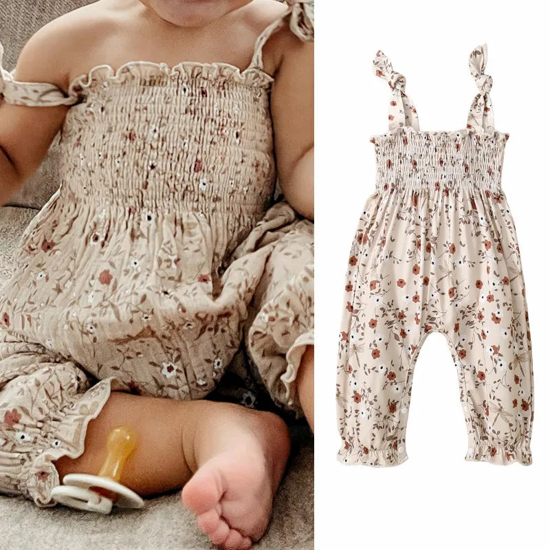 Bubebaby BabyLove Floral Jumpsuit Romper. The romper features a floral pattern with a mix of tranquil colors. Featuring an elasticized chest with shoulder straps, and snap closures at the bottom for easy diaper changes.