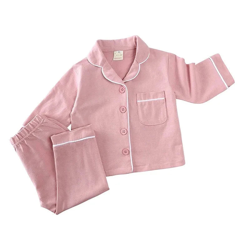 Discover our luxurious unisex cotton pajamas for kids aged 12 Mo- 5 Years at Bubebaby. Perfect for autumn, these solid-colored pajamas feature a classic turn-down collar and regular sleeves, offering comfort and style for your little ones