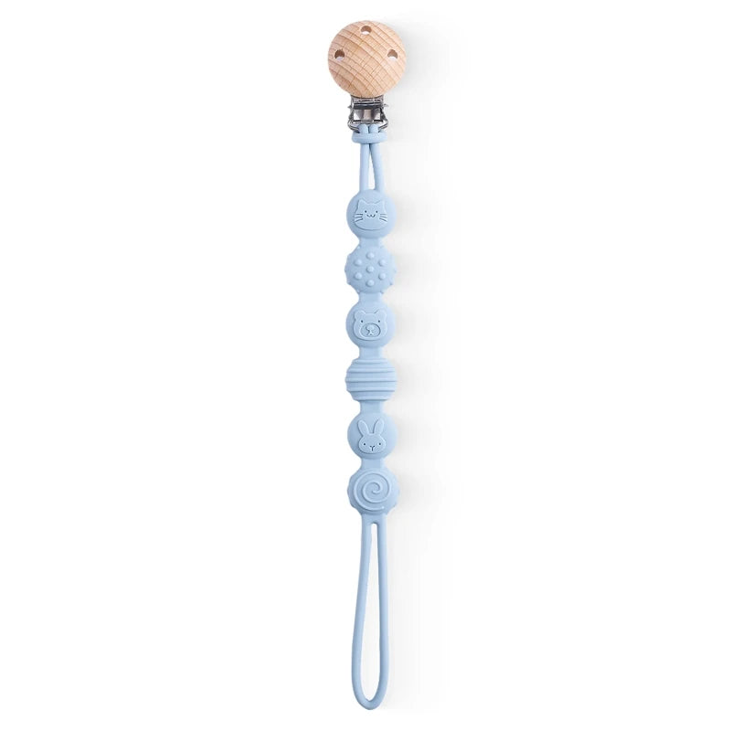 BabyLove Montessori Beech Wood and Silicone Beaded Pacifier Clip, a 20cm durable, BPA-free, phthalate-free, and latex-free accessory for babies aged 0-36 months. Features a solid color, wooden clip, and silicone strap. Versatile as a pacifier holder, soother chain, or teether toy. Safe and stylish design