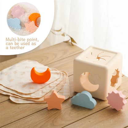 Babylove Silicone Tissue Box for kids aged 0-14+ years, free from high-concern chemicals. This Montessori toy enhances color recognition and shape pairing, made from high-quality silicone with a shape and nature theme. Ideal for developing early learning skills