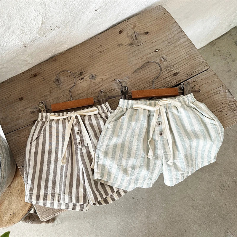 Shop our BabyLove Vintage Striped Shorts at BubeBaby. Perfect for summer, these unisex shorts feature a European and American style with a solid pattern. Made from soft cotton, they fit true to size and come in sizes ranging from 6-12m to 4-5T. Available in coffee, green, and beige. Ideal for ages 0-6 years