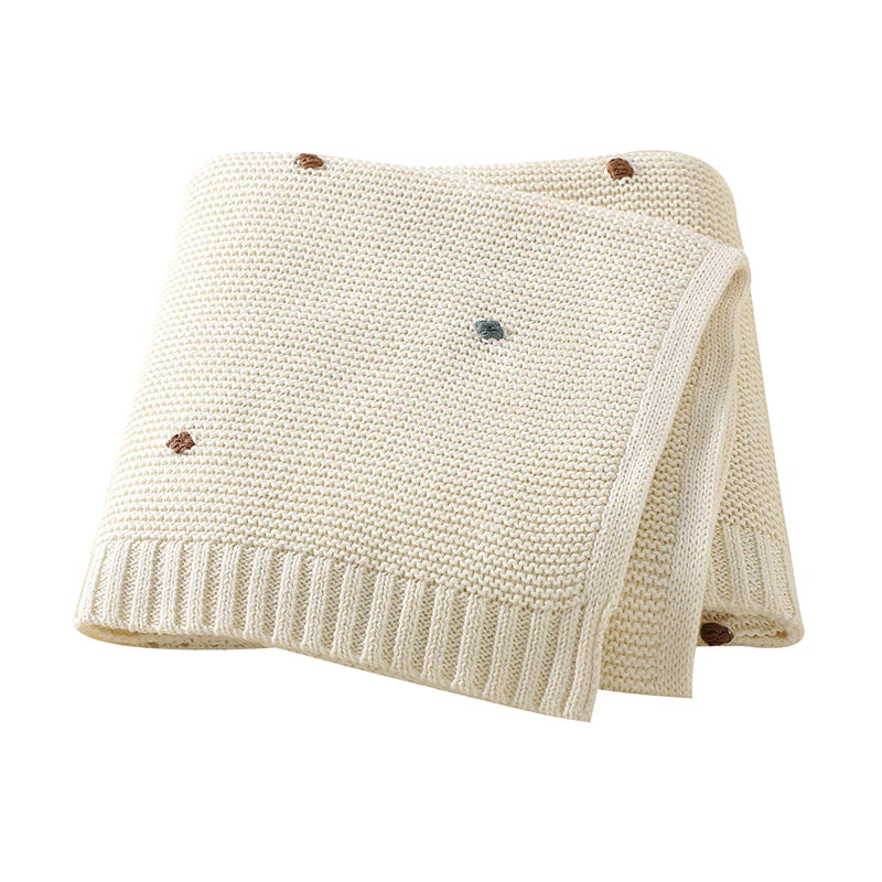 Nursery Knitted Newborn Baby Blanket at BubeBaby. Made from 100% cotton, this unisex blanket is perfect for babies aged 0-24 months. Featuring a versatile dot pattern, it’s ideal for all seasons. Soft and comfortable, it makes a great choice for keeping your baby cozy year-round