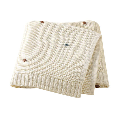 Nursery Knitted Newborn Baby Blanket at BubeBaby. Made from 100% cotton, this unisex blanket is perfect for babies aged 0-24 months. Featuring a versatile dot pattern, it’s ideal for all seasons. Soft and comfortable, it makes a great choice for keeping your baby cozy year-round