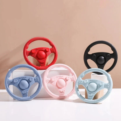 Silicone Bubebaby BabyLove Teething Toy Car Wheel – A fun and safe teether for babies, designed as an analog steering wheel. Made from 100% silicone, it's latex, nitrosamine, phthalate, BPA, and PVC free. Suitable for infants from 0 to 36 months. Available in various colors and comes in single packaging