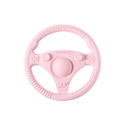 Silicone Bubebaby BabyLove Teething Toy Car Wheel – A fun and safe teether for babies, designed as an analog steering wheel. Made from 100% silicone, it's latex, nitrosamine, phthalate, BPA, and PVC free. Suitable for infants from 0 to 36 months. Available in various colors and comes in single packaging