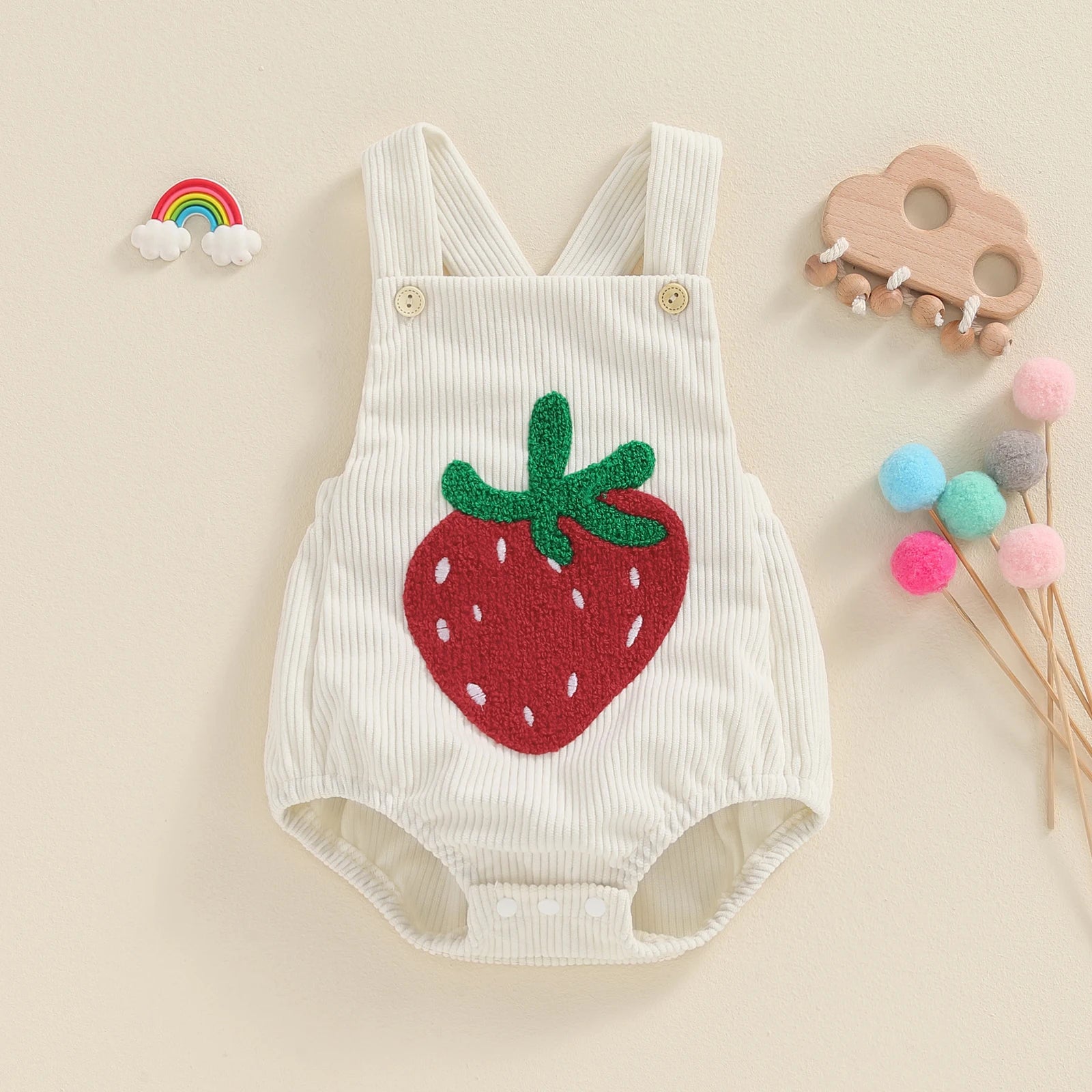 Keep your baby girl stylish and comfy with our BabyLove Floral Rainbow and Strawberry Romper! Perfect for ages 0-12 months, this sleeveless romper features a square neck, playful patterns, and a soft cotton-polyester blend. Lightweight and breathable, it's ideal for summer days. Fits true to size with covered button closures