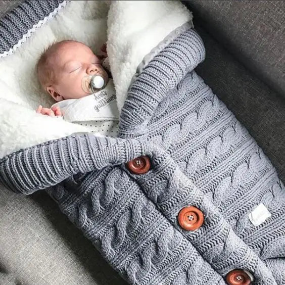 Nursery Knitted Sleeping Bag Cover at BubeBaby, designed for babies 0-12 months. Made from cozy wool and nylon, this unisex sleep sack is perfect for winter. Features include a solid pattern, knitted linen flower color, and measures 68x40 cm. Lightweight at 420g and packaged in a 40x32x3 cm box