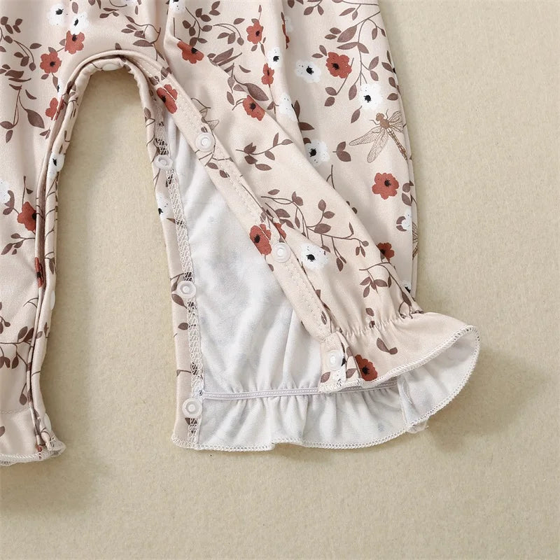 Bubebaby BabyLove Floral Jumpsuit Romper. The romper features a floral pattern with a mix of tranquil colors. Featuring an elasticized chest with shoulder straps, and snap closures at the bottom for easy diaper changes.