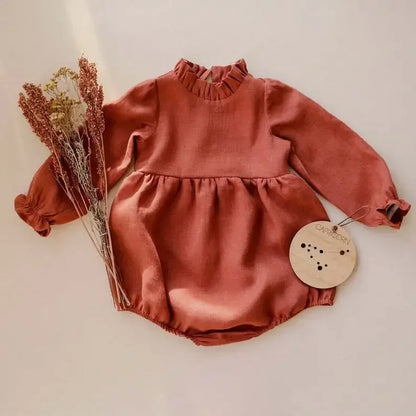 Bubebaby BabyLove Cotton Ruffled Long Sleeve buttoned Romper.  A cute and cozy baby romper made from soft cotton fabric, featuring long sleeves, a ruffled collar and wrists, with a snap closure for easy dressing. 