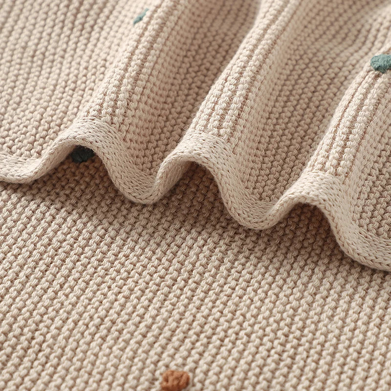 Nursery Knitted Newborn Baby Blanket at BubeBaby. Made from 100% cotton, this unisex blanket is perfect for babies aged 0-24 months. Featuring a versatile dot pattern, it’s ideal for all seasons. Soft and comfortable, it makes a great choice for keeping your baby cozy year-round