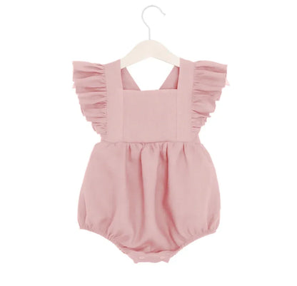 Shop BabyLove Ruffled Romper at BubeBaby, perfect for baby girls aged 0-24 months. Made from soft cotton, this sleeveless romper features a ruffled design and a covered button closure. Available in sizes for 3-24 months, it fits true to size and is ideal for summer