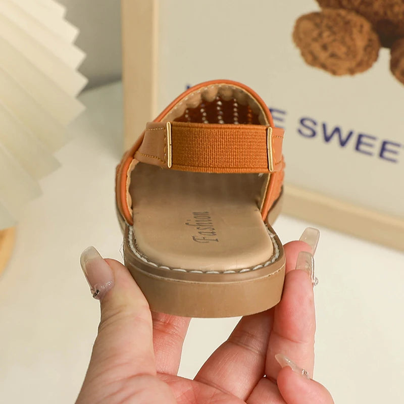 Discover BabyLove Woven Slip-On Sandals at BubeBaby, perfect for summer. These breathable sandals feature cut-outs and a soft leather style with a flat heel. Available in sizes from 14.5cm to 21.5cm, they fit true to size and offer a comfortable, stylish option for ages 4-6Y. Use our size guide for the perfect fit