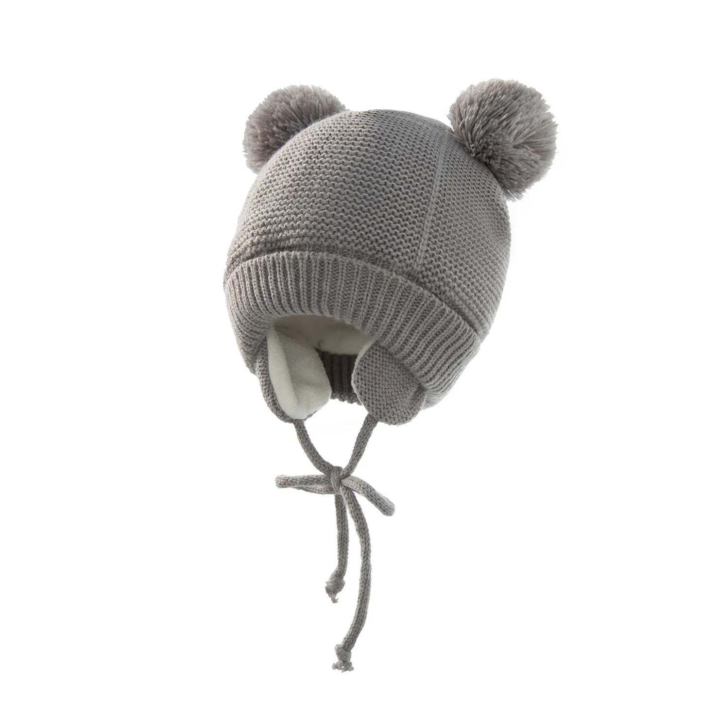 Shop the BabyLove Winter Knitted Bonnet at BubeBaby, perfect for keeping little ones warm in winter. Made from soft acrylic, this unisex bonnet features a solid pattern and ear protection design