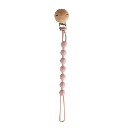 BabyLove Montessori Beech Wood and Silicone Beaded Pacifier Clip, a 20cm durable, BPA-free, phthalate-free, and latex-free accessory for babies aged 0-36 months. Features a solid color, wooden clip, and silicone strap. Versatile as a pacifier holder, soother chain, or teether toy. Safe and stylish design