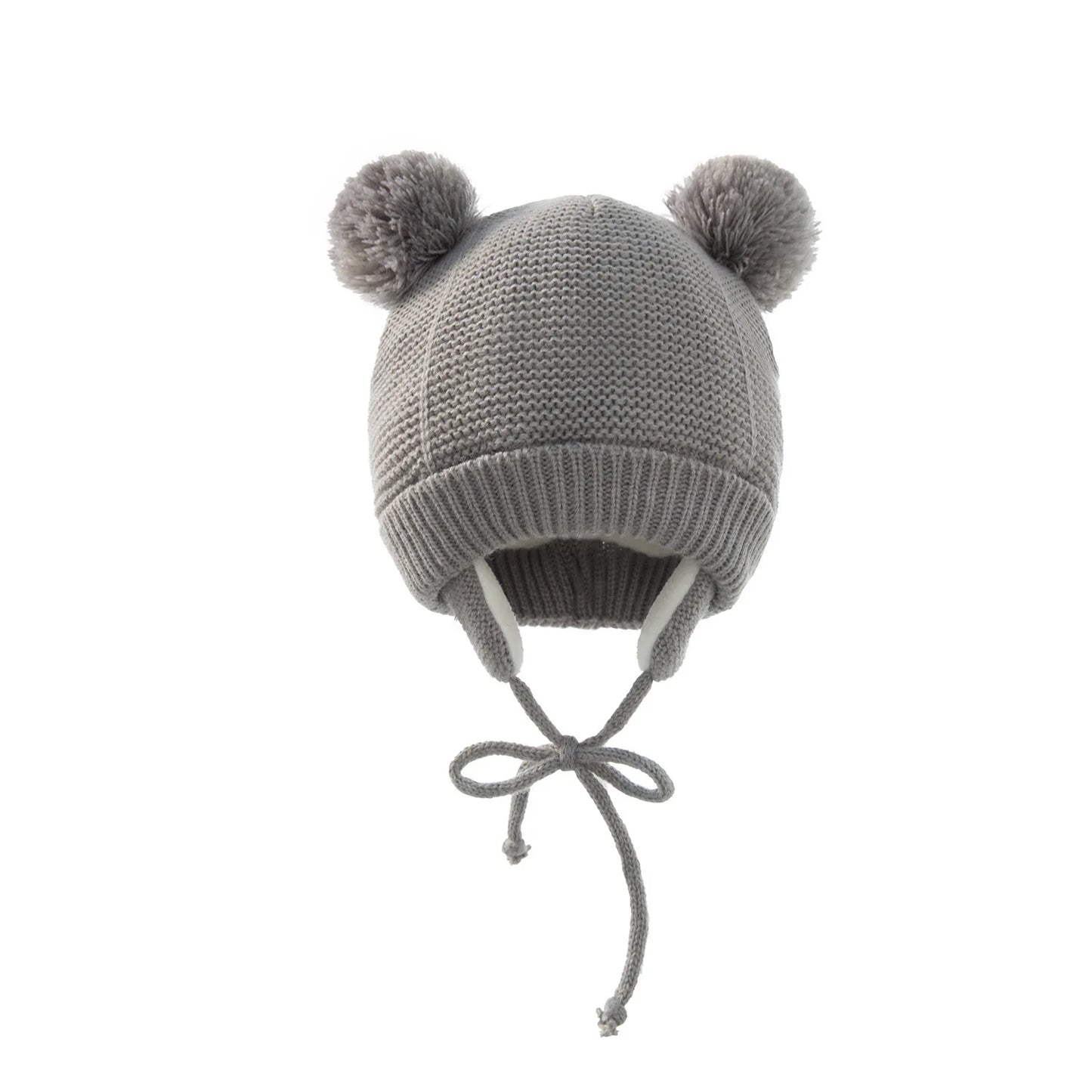 Shop the BabyLove Winter Knitted Bonnet at BubeBaby, perfect for keeping little ones warm in winter. Made from soft acrylic, this unisex bonnet features a solid pattern and ear protection design